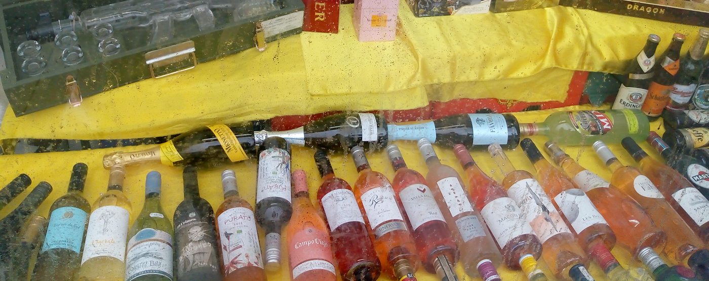Rows of white and rosé wine bottles on display in the window at Wine Cellar, Dalston